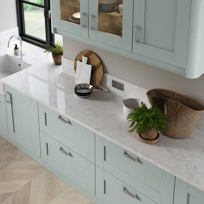 Light duck egg blue kitchen cabinetry and white polished granite worksurfaces